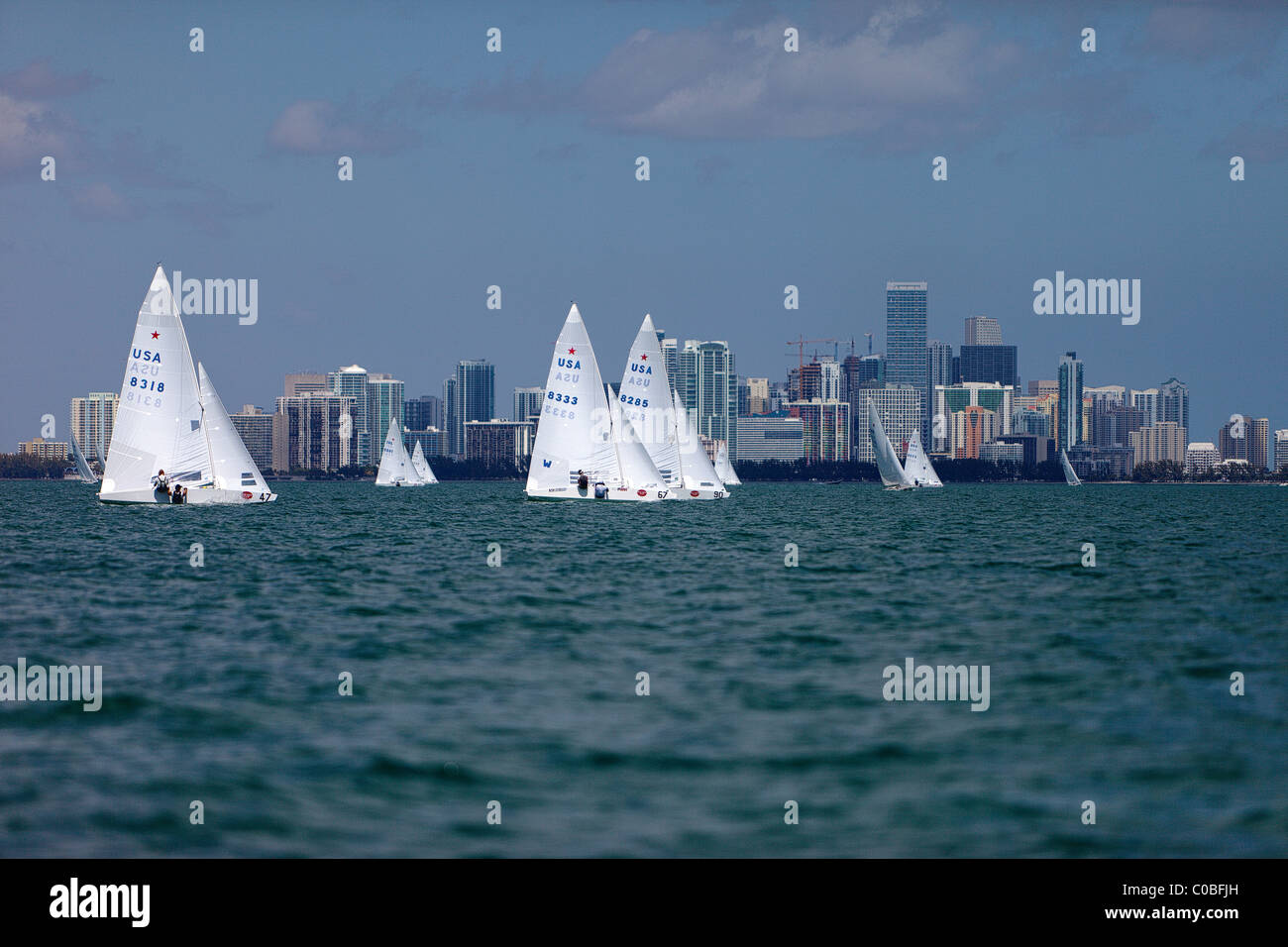 Star Class sailboat racing on Biscayne Bay passing Miami Skyline Stock Photo