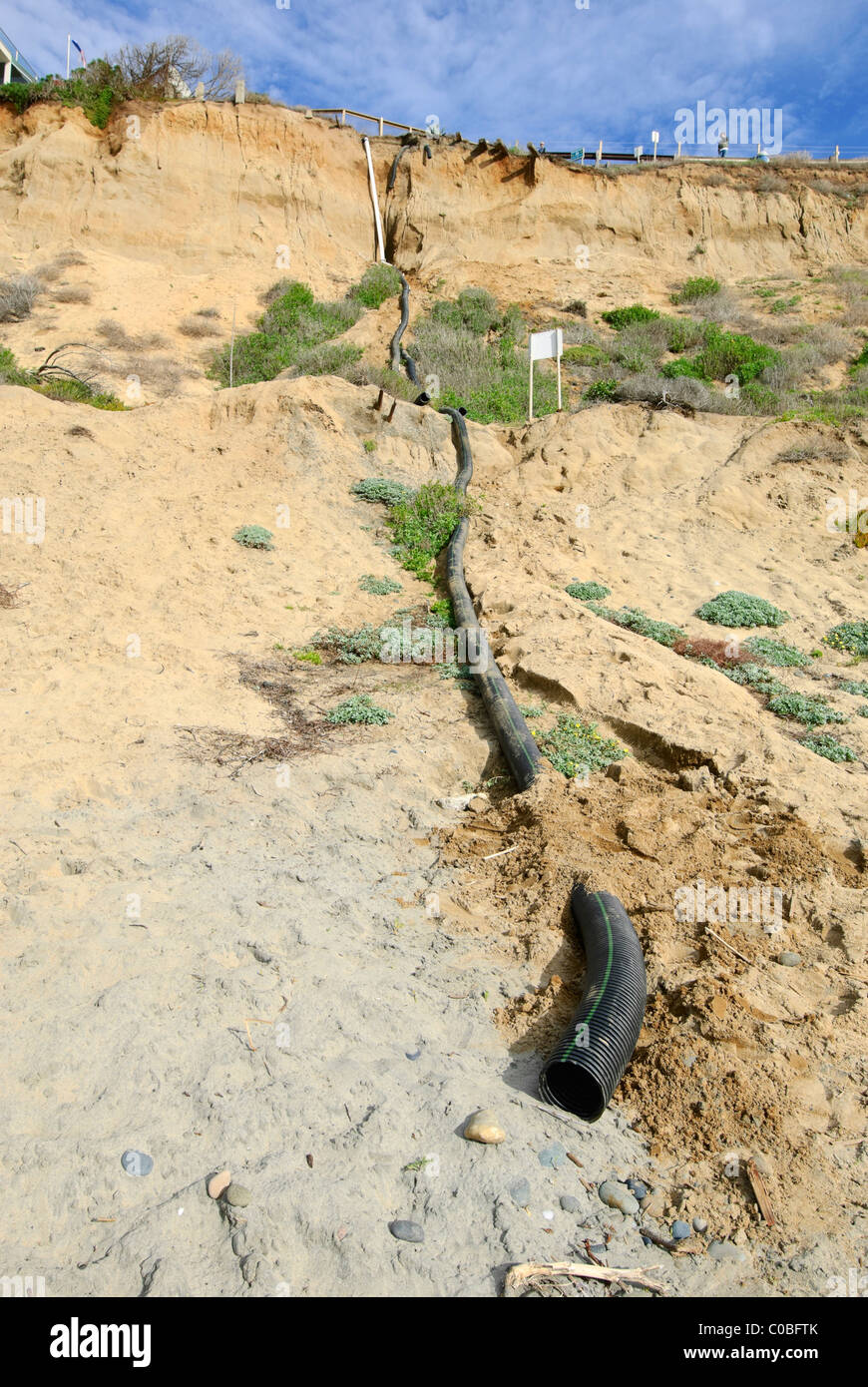 Plastic corrugated tubing for runoff water to exit protecting the coastal bluffs from further