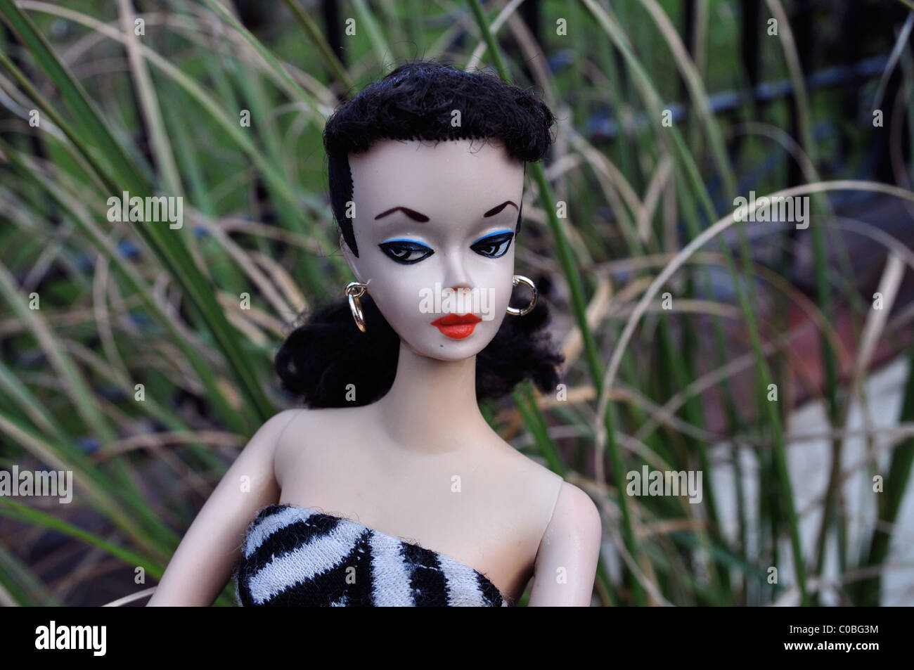 First Barbie doll made by Mattel in 1959 with arched eyebrows and black and  white painted eyes in original zebra swimsuit Stock Photo - Alamy
