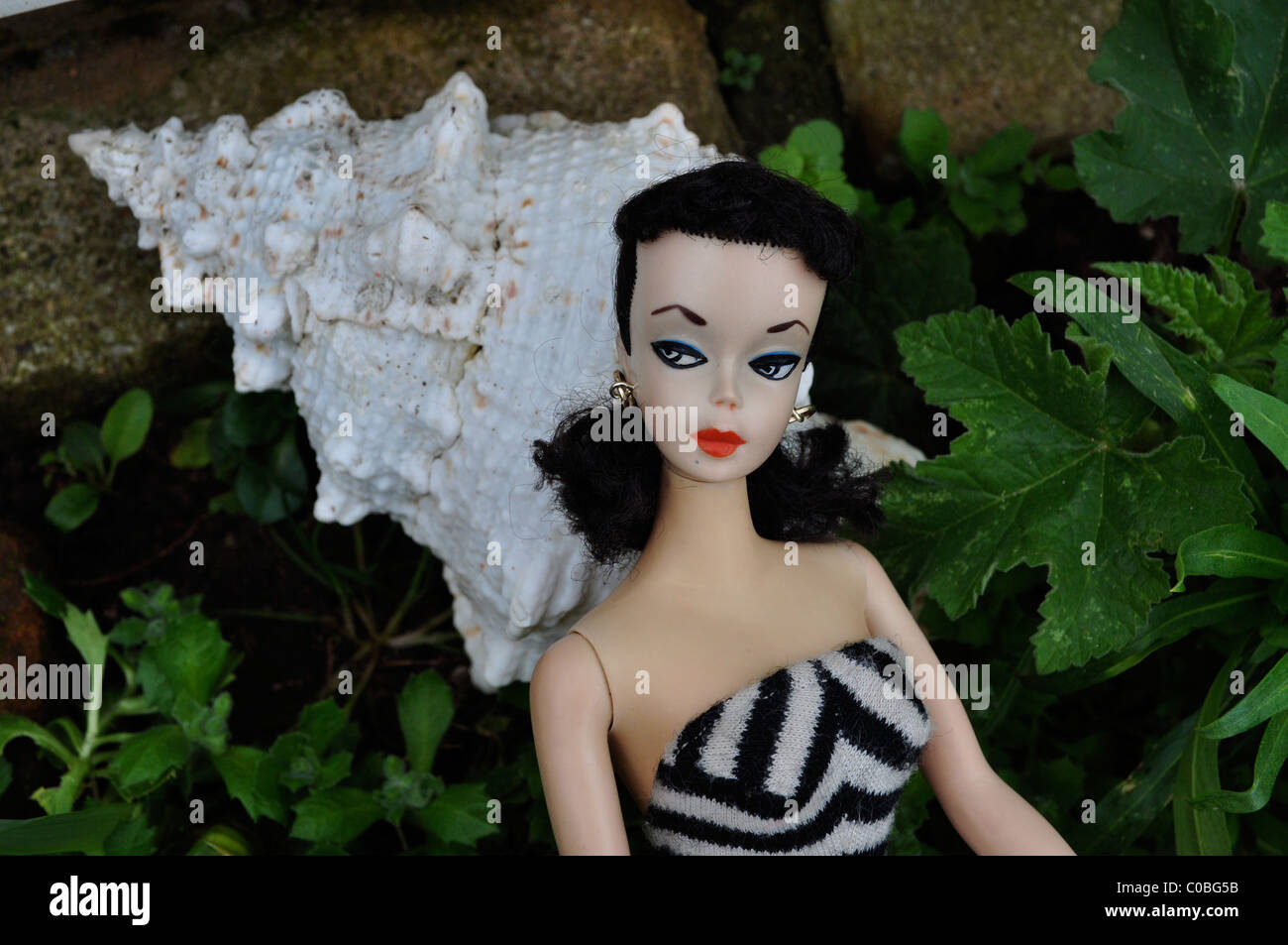 First Barbie doll made in 1959 in Japan, #1 Barbie doll with arched  eyebrows, black and white eye paint and matching swimsuit Stock Photo -  Alamy
