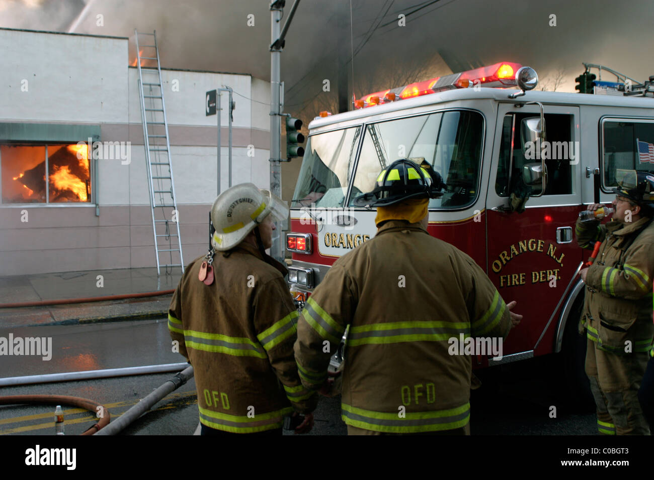 Firefighters at scene of a large store fire in New Jersey Stock Photo