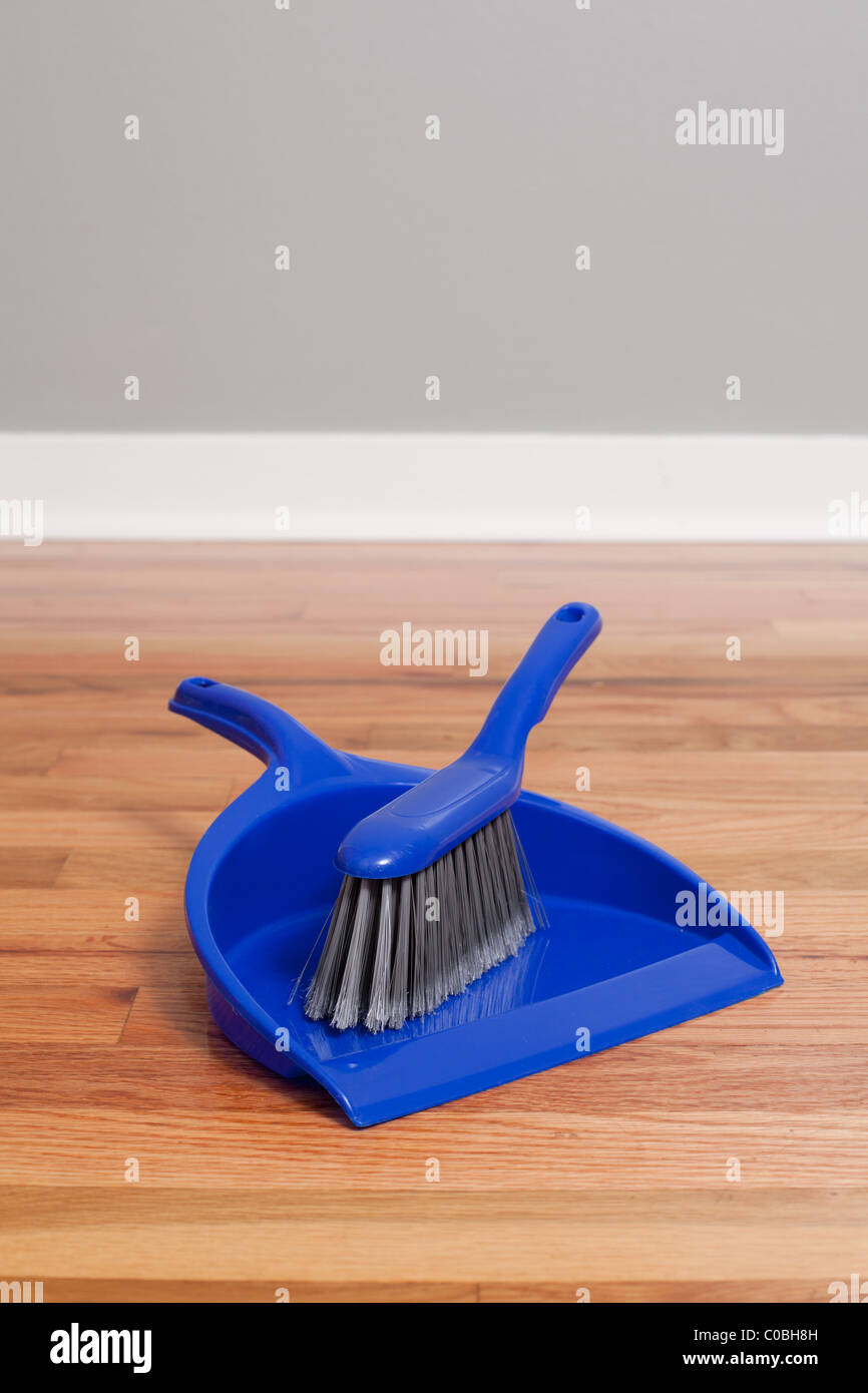 A dust pan and brush on Hardwood Floor Stock Photo Alamy