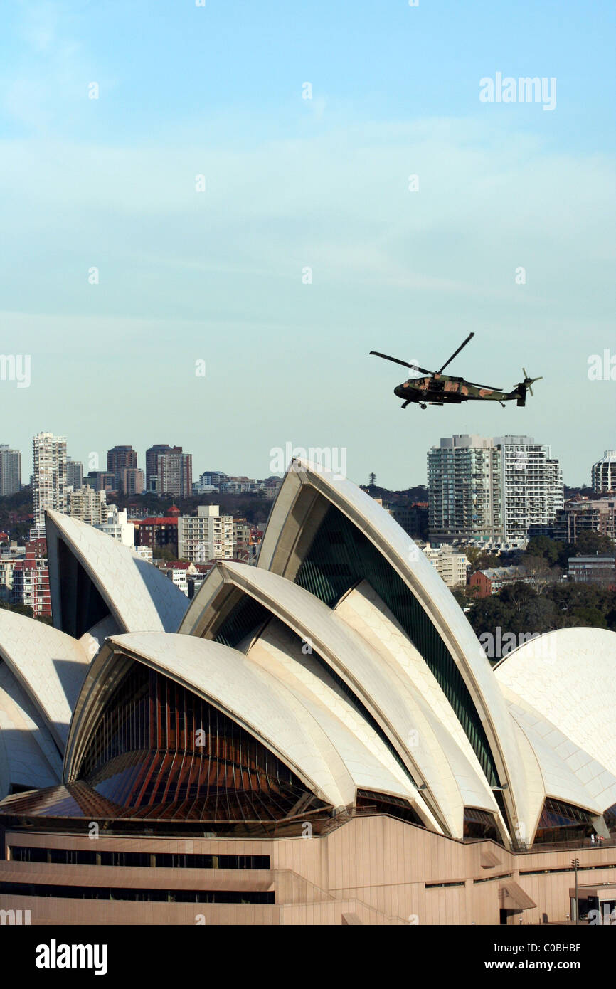 An Australian Army Black Hawk helicopter passes over the Sydney Opera House, New South Wales, Australia. Stock Photo