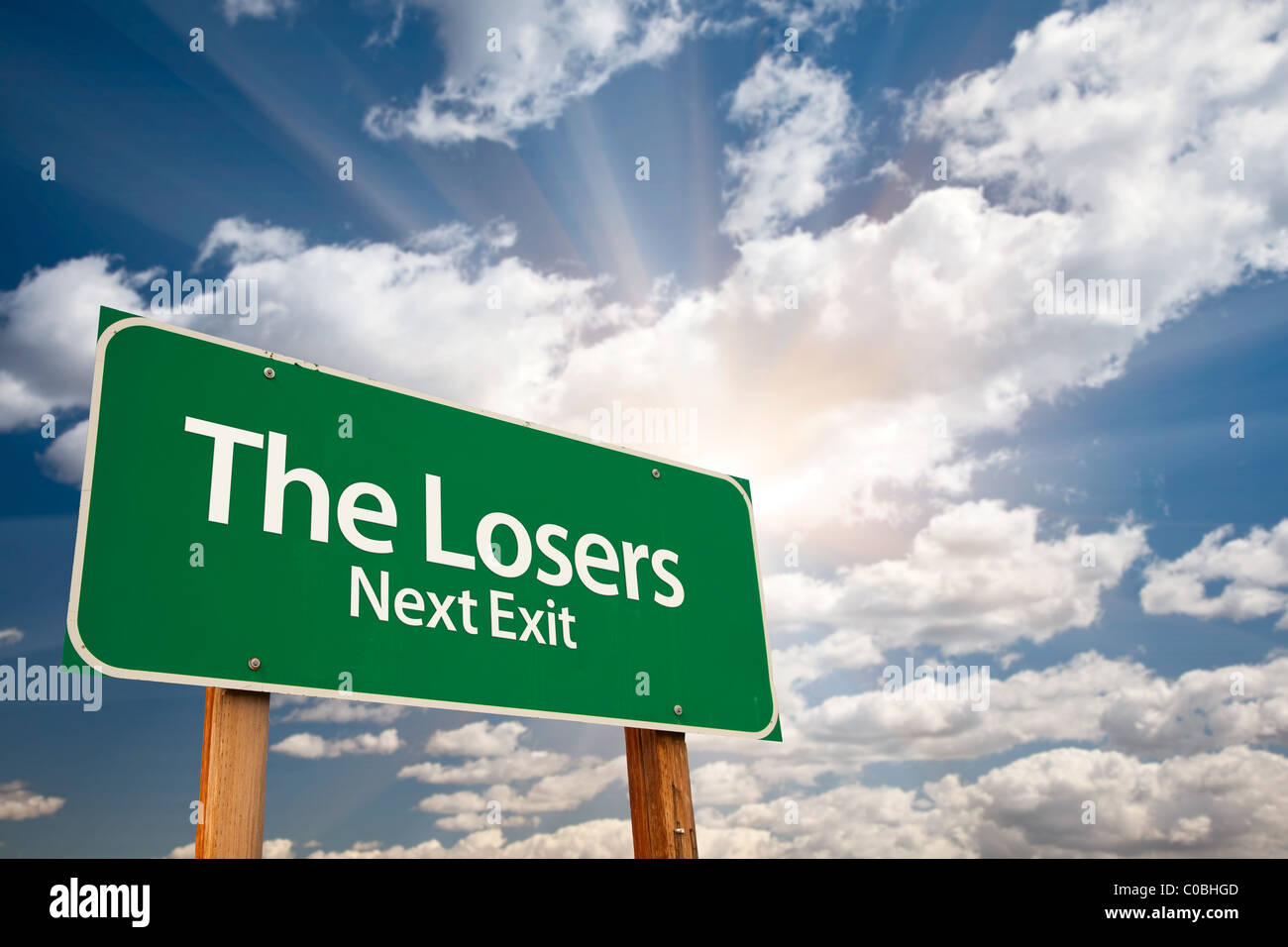 The Losers Green Road Sign with Dramatic Clouds, Sun Rays and Sky. Stock Photo