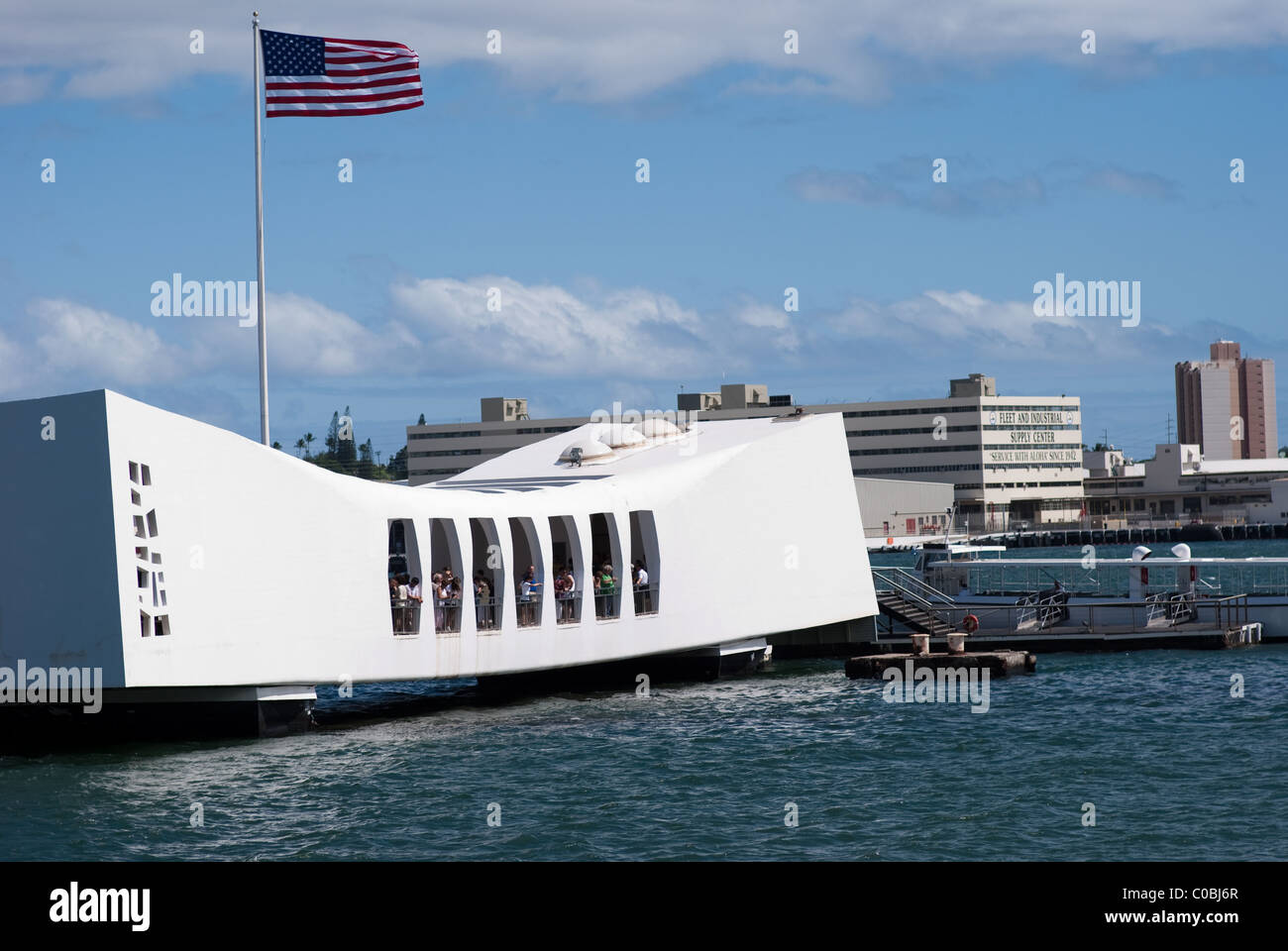 Arizona Memorial, Pearl Harbor Hawaii. US Flag flying high above USS Arizona war memorial. Stock Photo