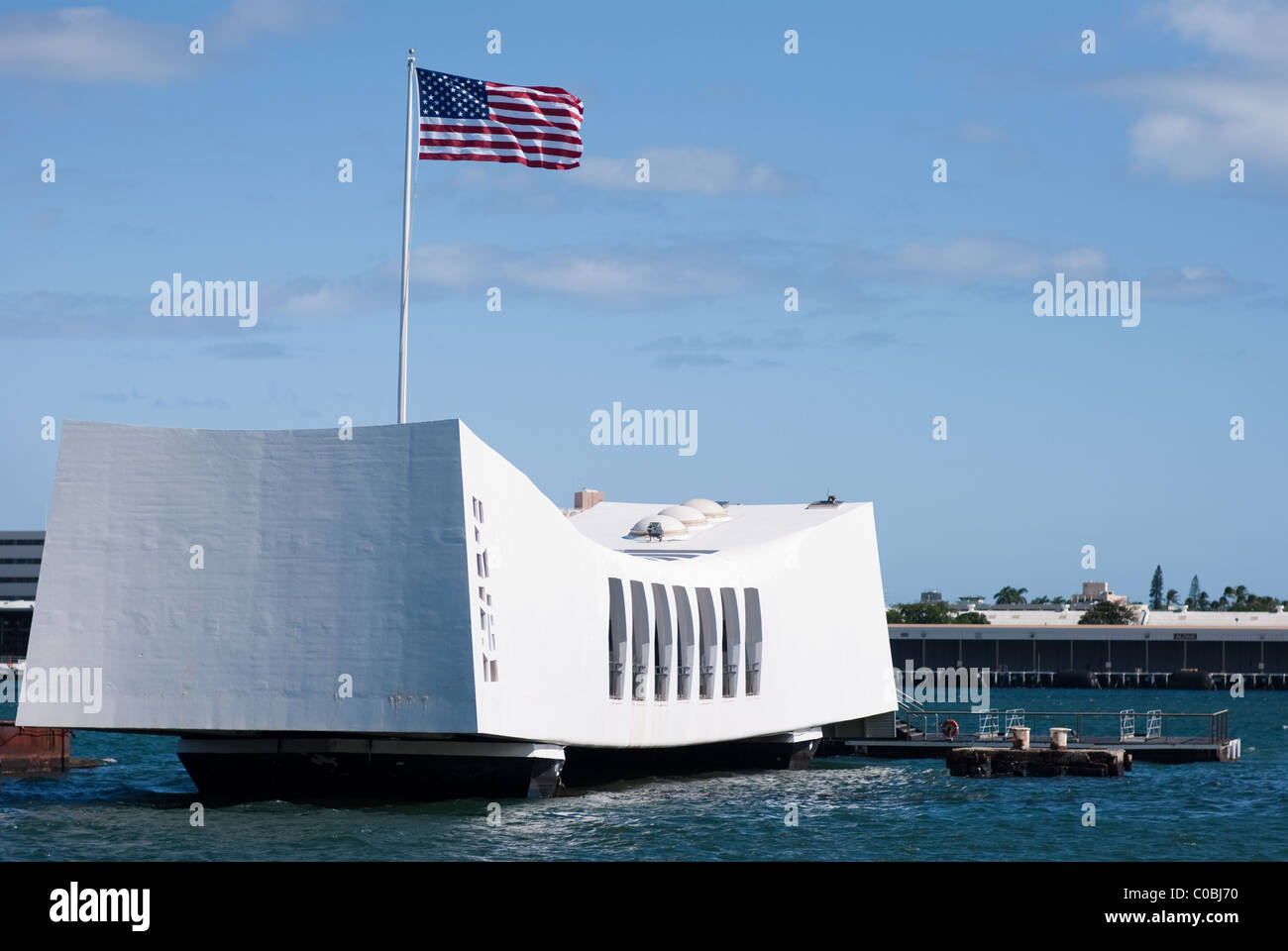 Arizona Memorial, Pearl Harbor Hawaii. US Flag flying high above USS Arizona war memorial. Stock Photo