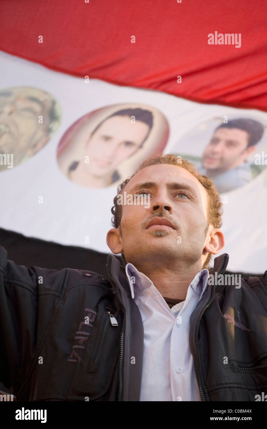 A man stands before an Egyptian flag in Tahrir Square hours before President Mubarak steps down from office on Feb.11, 2011 Stock Photo