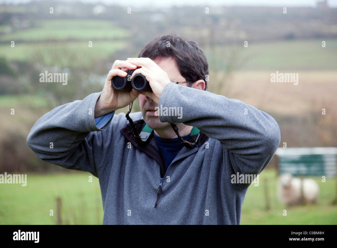 Using binoculars; bird watching; male Stock Photo Alamy
