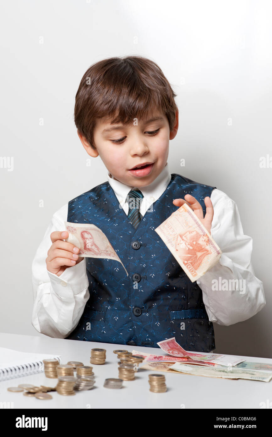 Child counting money and taking notes Stock Photo - Alamy