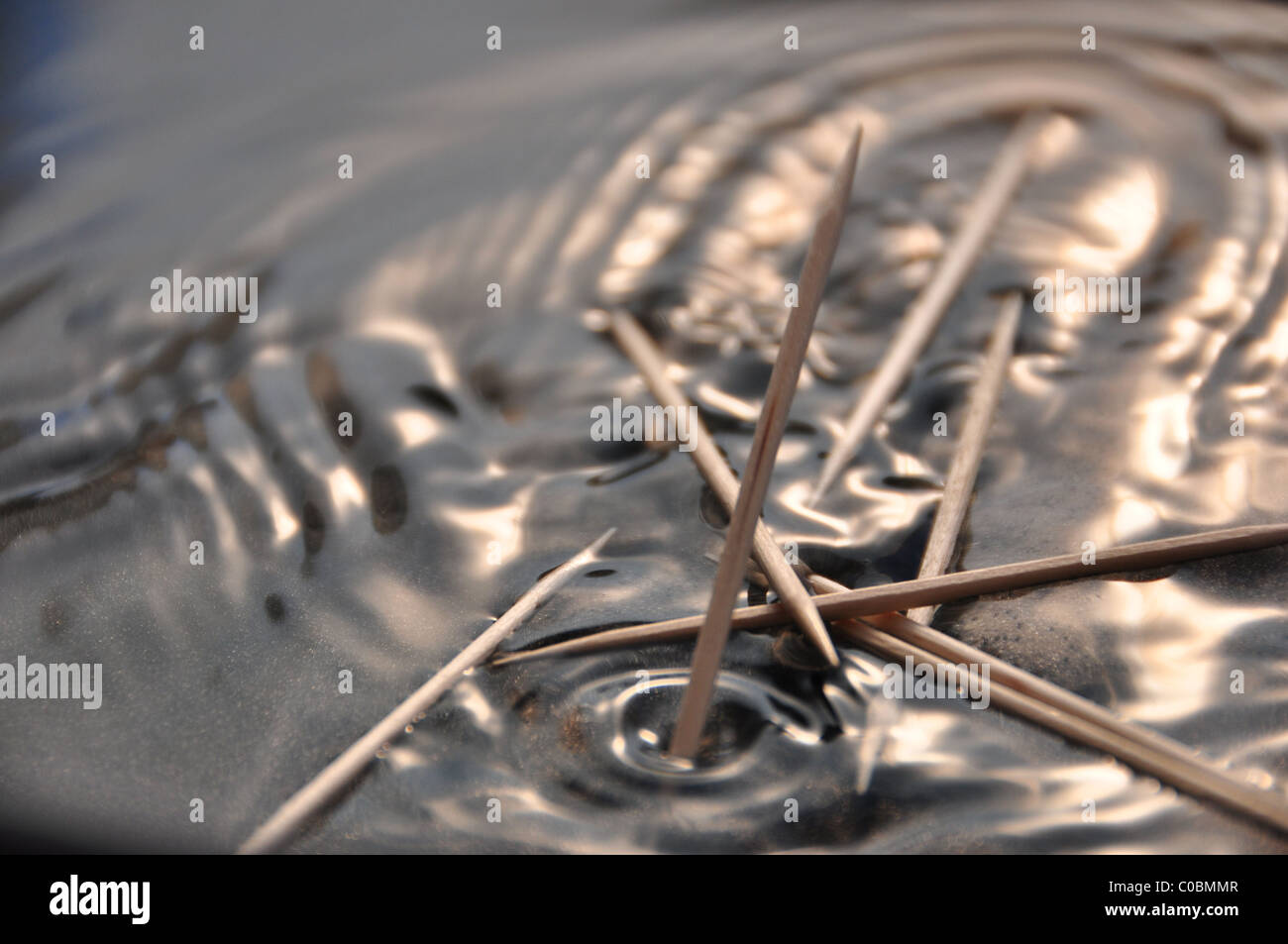 Toothpicks falling into water, macro photo Stock Photo Alamy