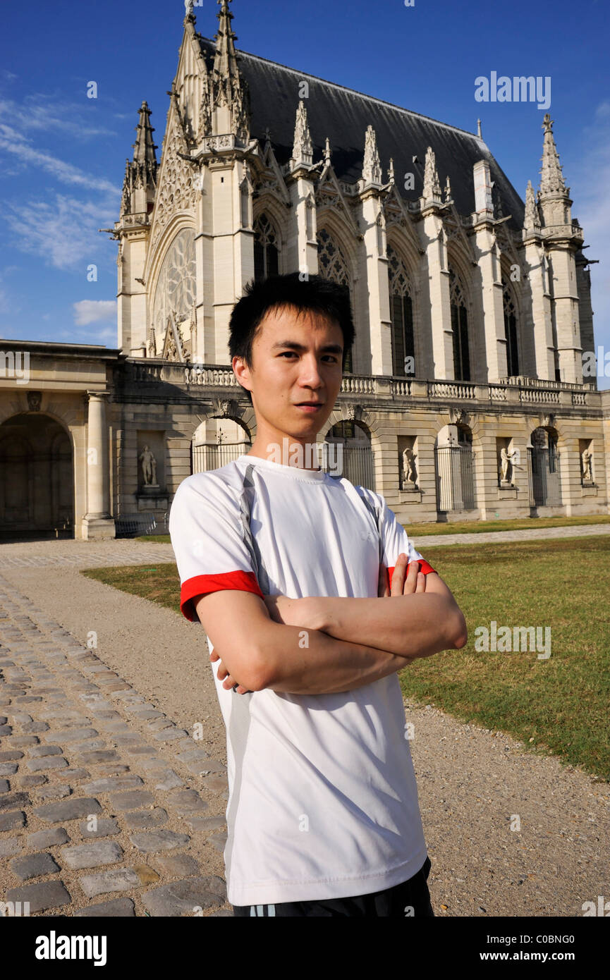 Paris, France, Portrait Young Chinese Man, Crossed arms, tourist Standing near 'Chateau de Vincennes' French Castle, europe chinese tourist student front of French chateau, china portraits Stock Photo