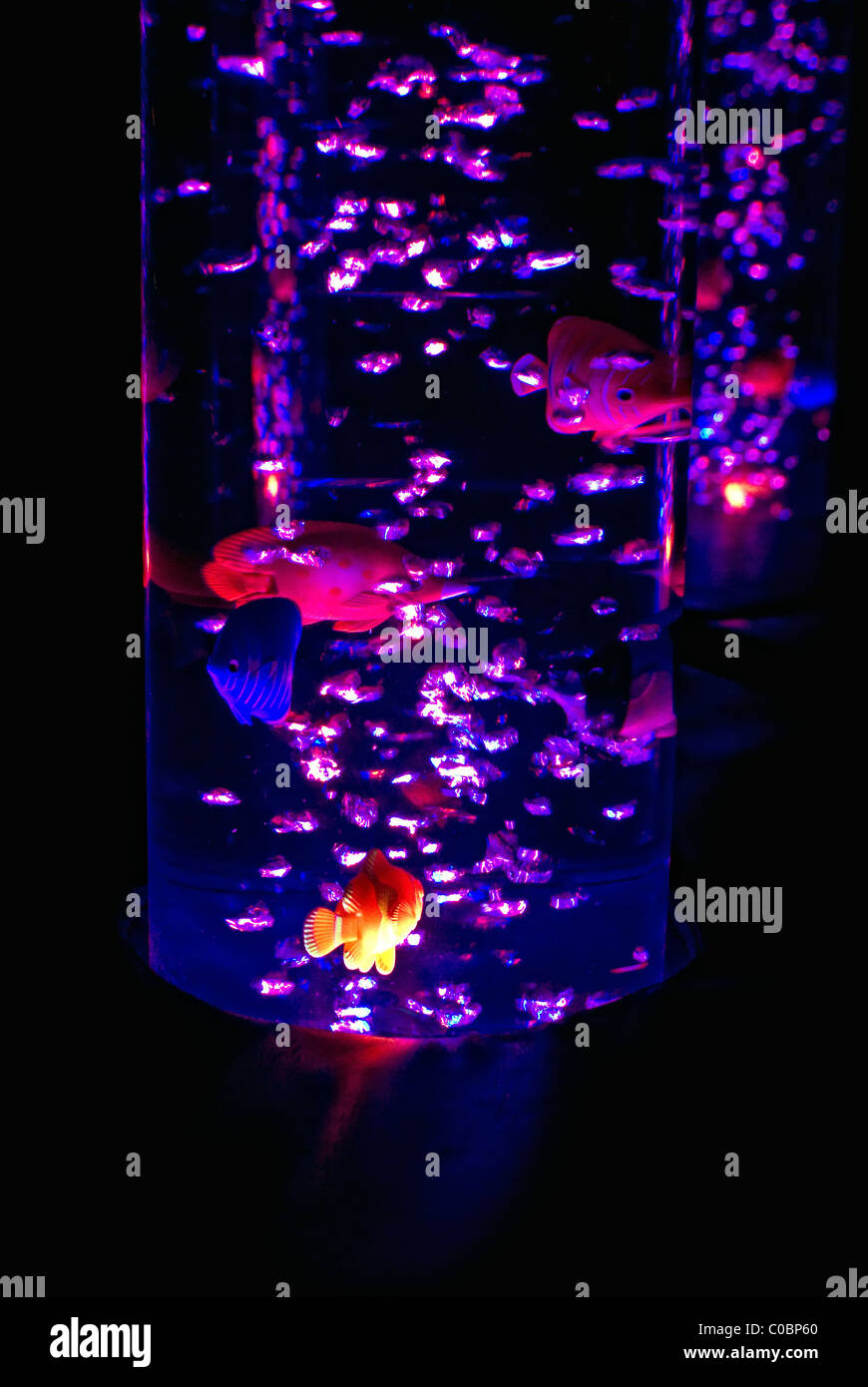 Bubble light tube with toy fish. Stock Photo