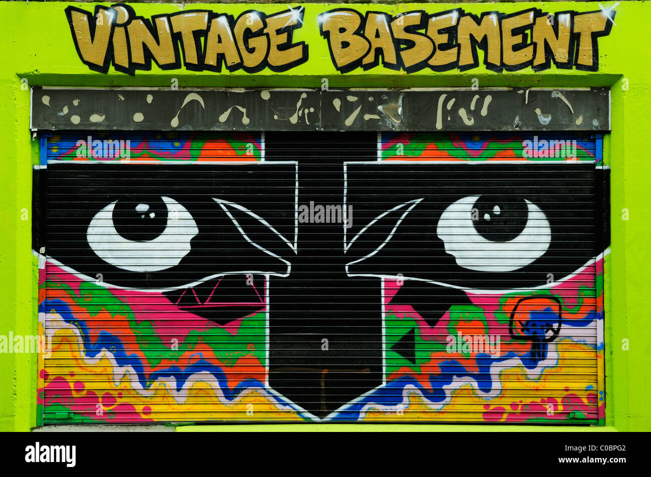 Graffiti on Vintage Basement Shop Grille, Brick Lane, London, England, UK Stock Photo