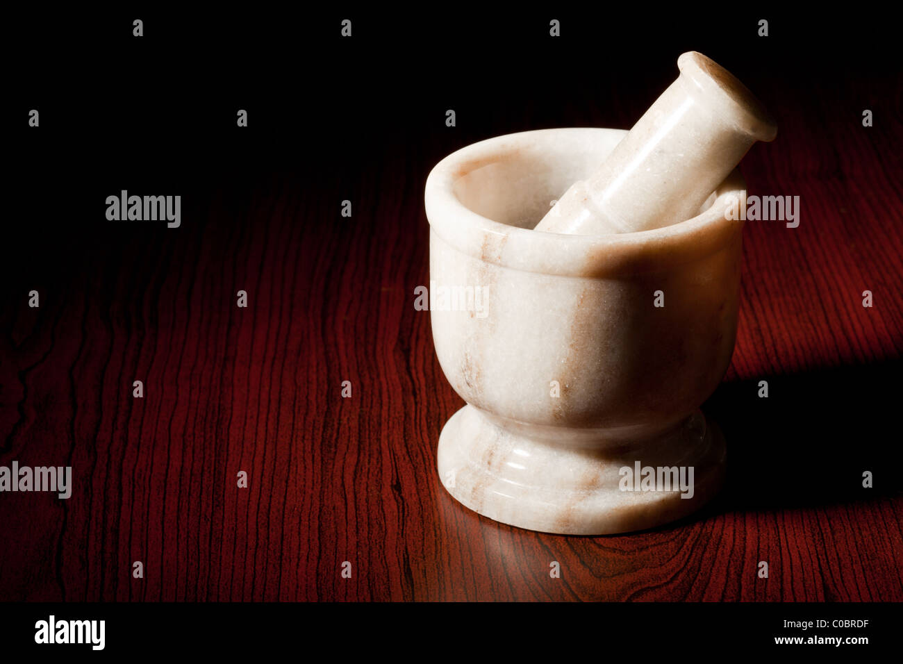 Marble mortar and pestle on dark wood background Stock Photo - Alamy