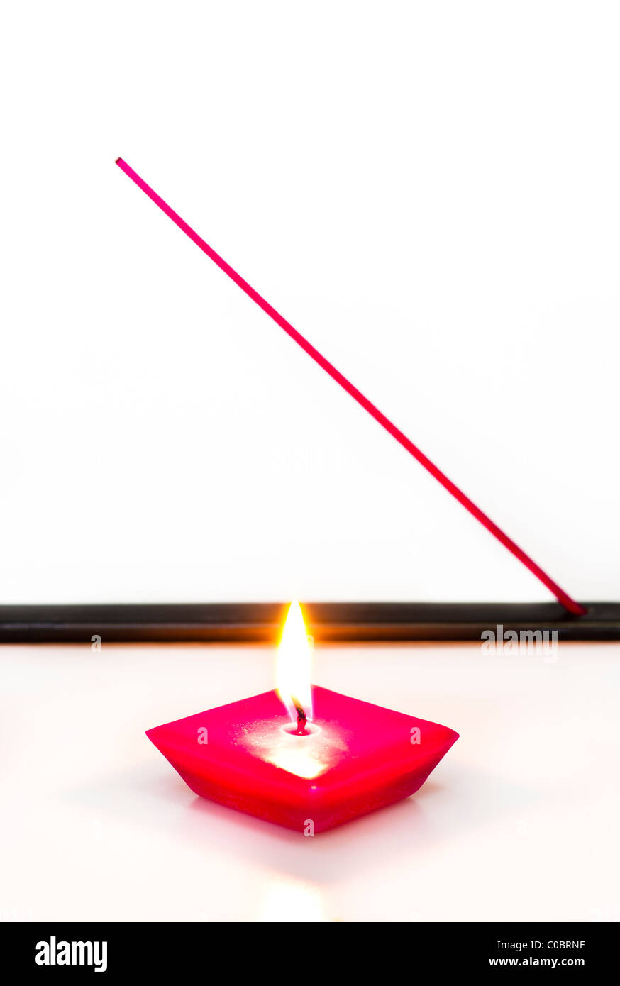 Burning Candle and Incense Stick in Holder on a White Background Stock ...