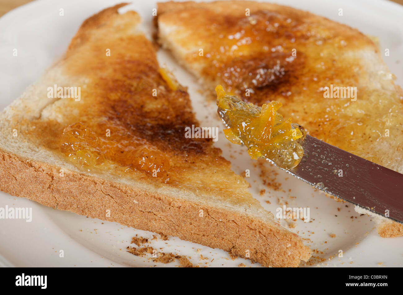 Marmalade on buttered toast Stock Photo Alamy