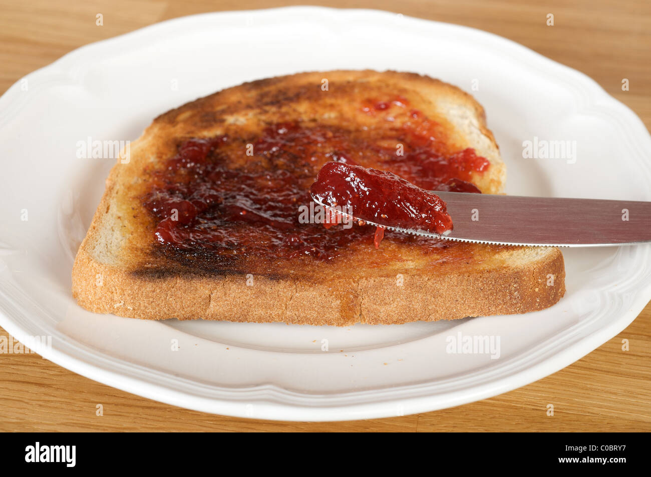 Strawberry jam on toast Stock Photo Alamy