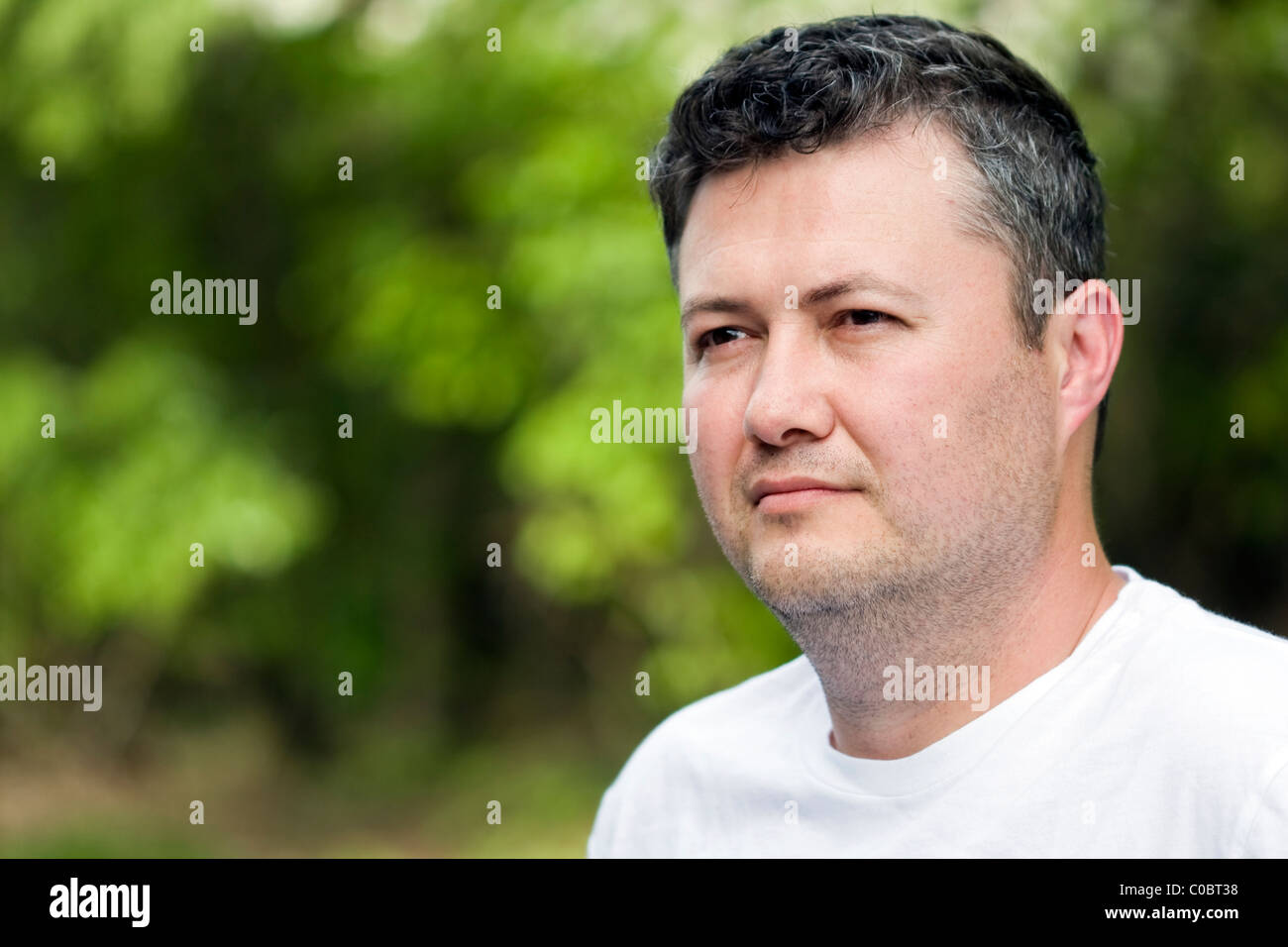 Enigmatic smile of an middle eastern man Stock Photo