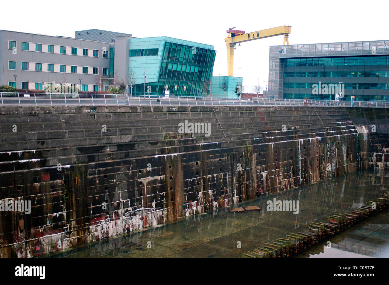 New Buildings, Harland and Wolff cranes around the Titanic Quarter are the backdrop to the Titanic Graving Dock in Belfast Stock Photo