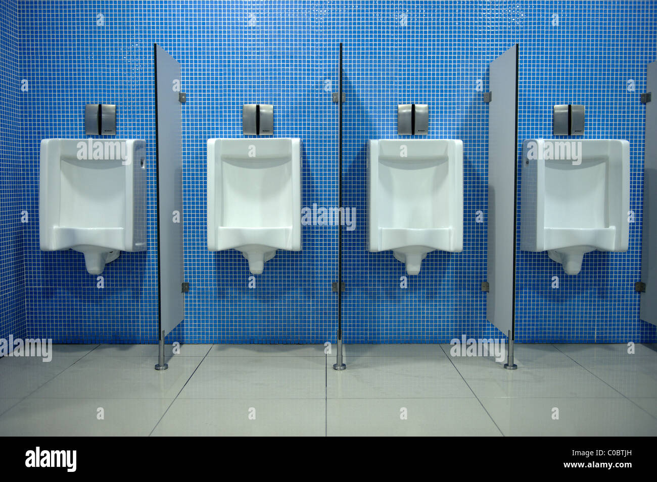 Row of urinals in a public restroom Stock Photo Alamy