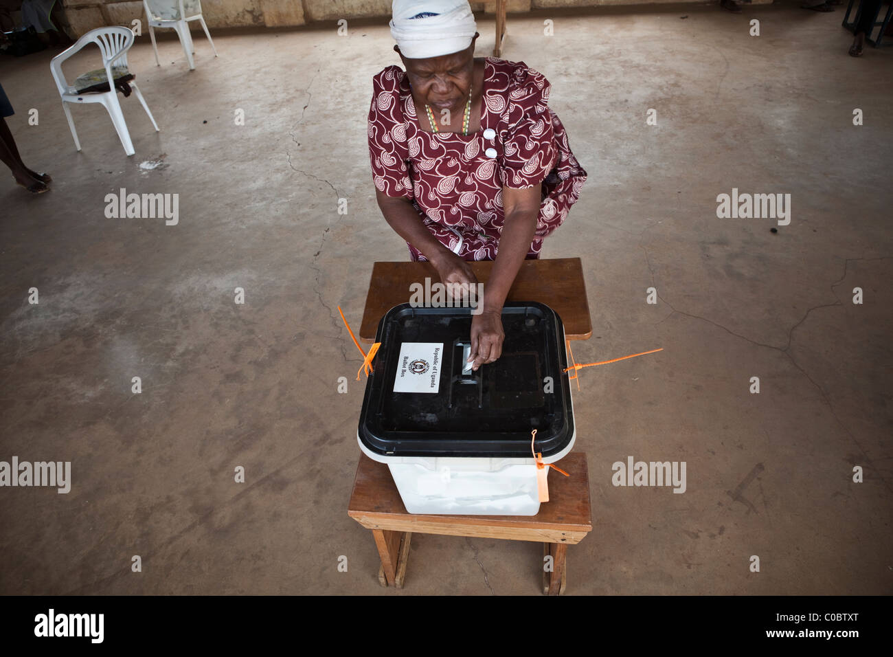 A woman casts her ballot at a polling station in Kumi, Uganda to cast her vote in the 2011 presidential election. Stock Photo