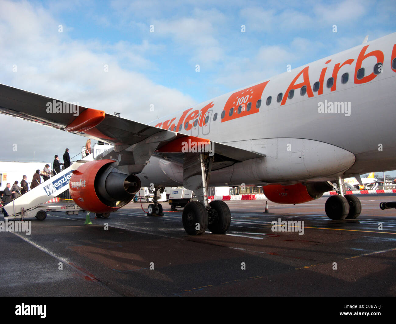 passengers boarding easyjet a319 airbus aircraft at Belfast International Airport. This aircraft was the 100th easyjet airbus Stock Photo