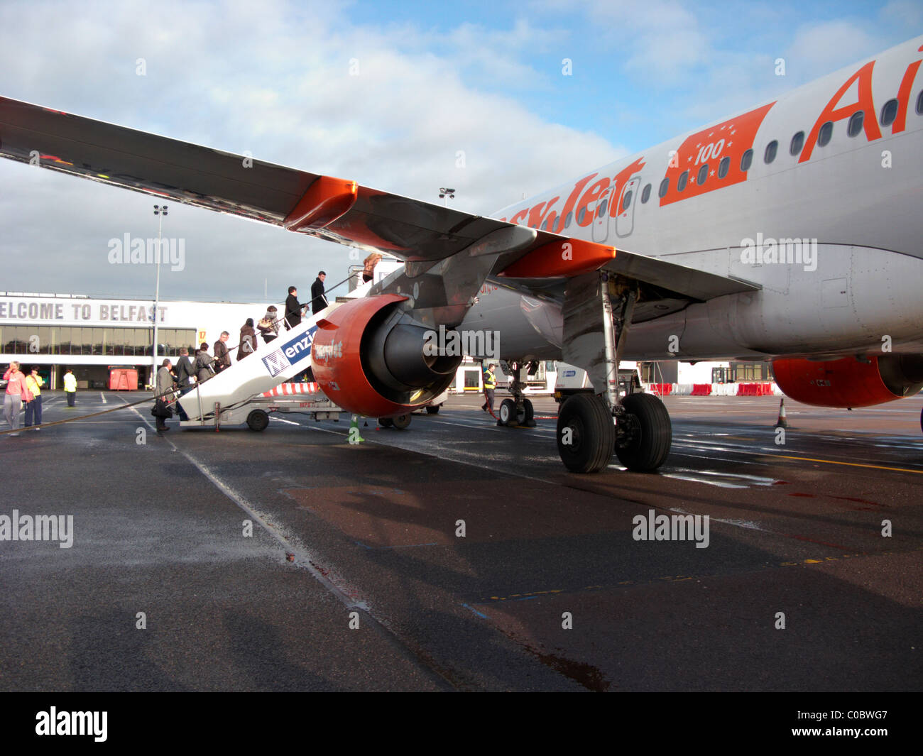 passengers boarding easyjet a319 airbus aircraft at Belfast International Airport. This aircraft was the 100th easyjet airbus Stock Photo