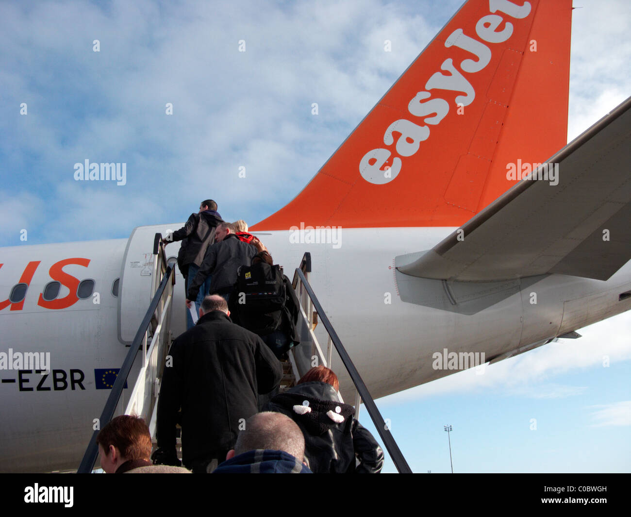 passengers boarding rear aircraft steps of easyjet a319 airbus aircraft at Belfast International Airport Stock Photo