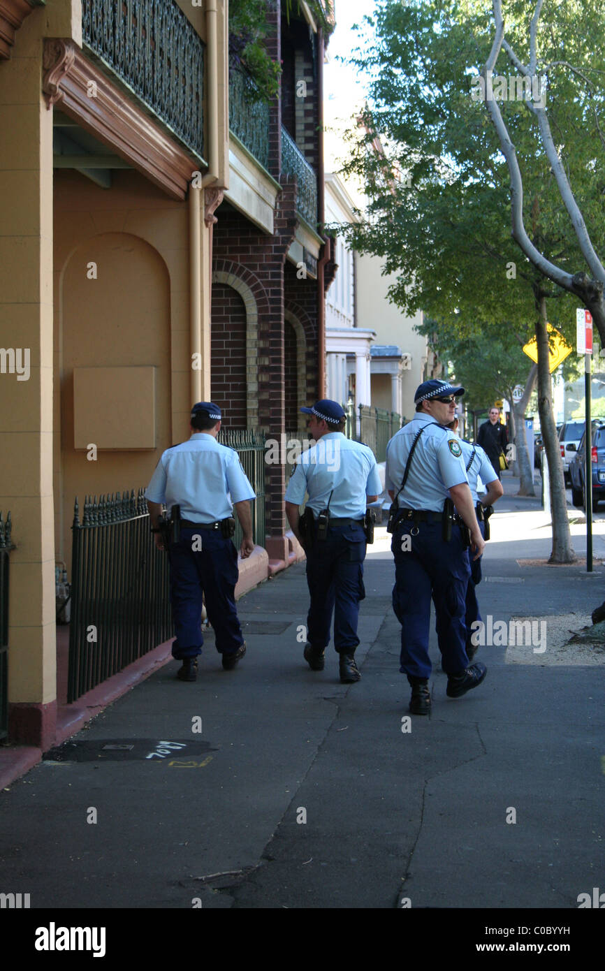 Australian police officers stroll the streets of the inner city during the St Patrick's Day celebrations, Sydney. NSW, Australia. Stock Photo
