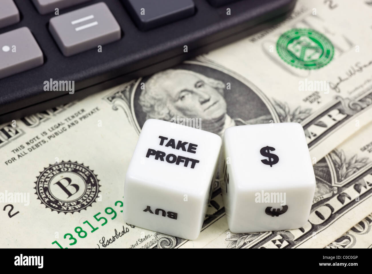 US currency with calculator and dice showing TAKE PROFIT Stock Photo