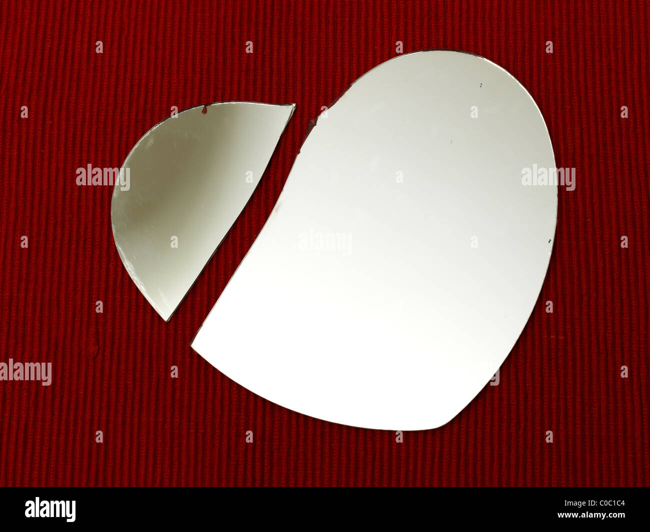 Broken Heart Shape Mirror On A Red Background Stock Photo