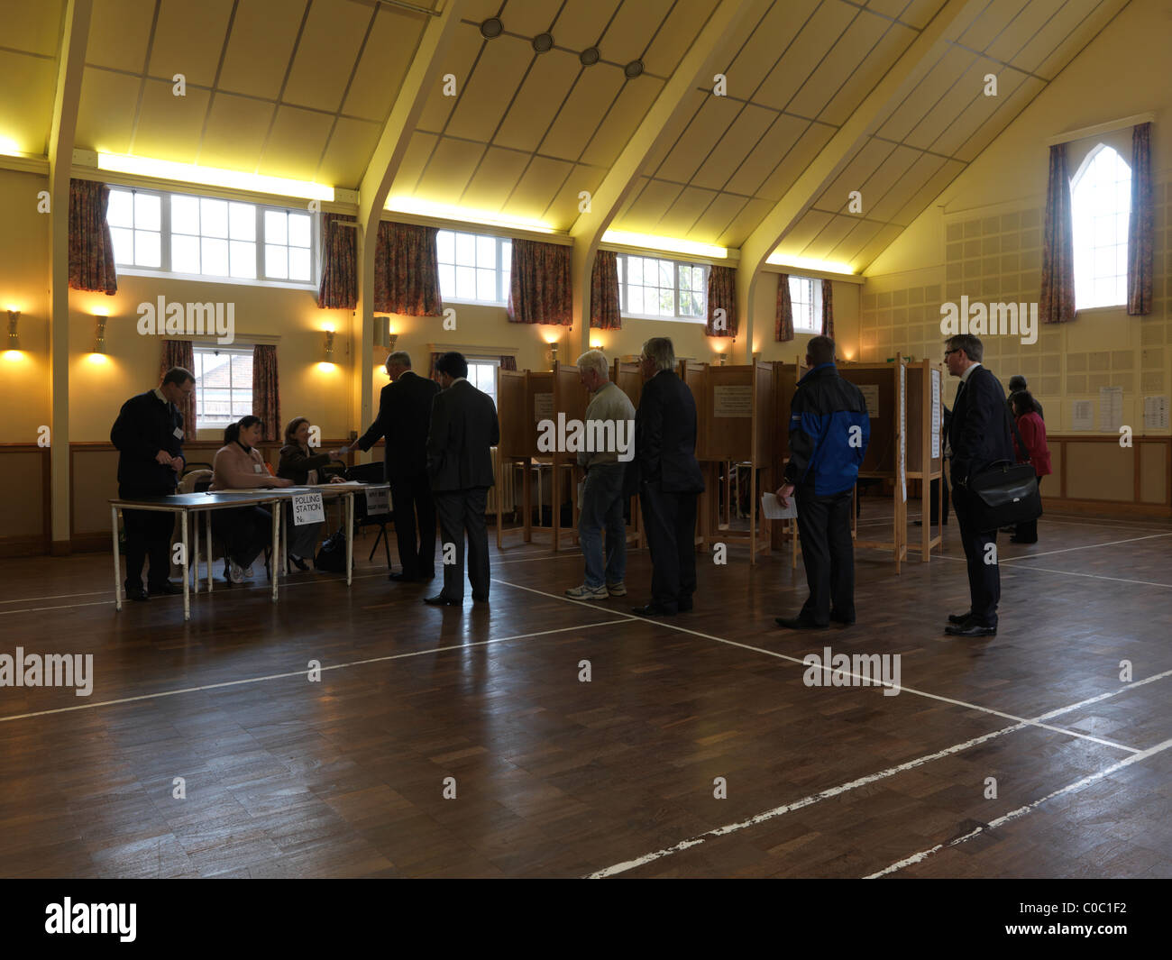 People Queuing Up To Get Voting Slips At General Election May 2010 in Church Hall England Stock Photo