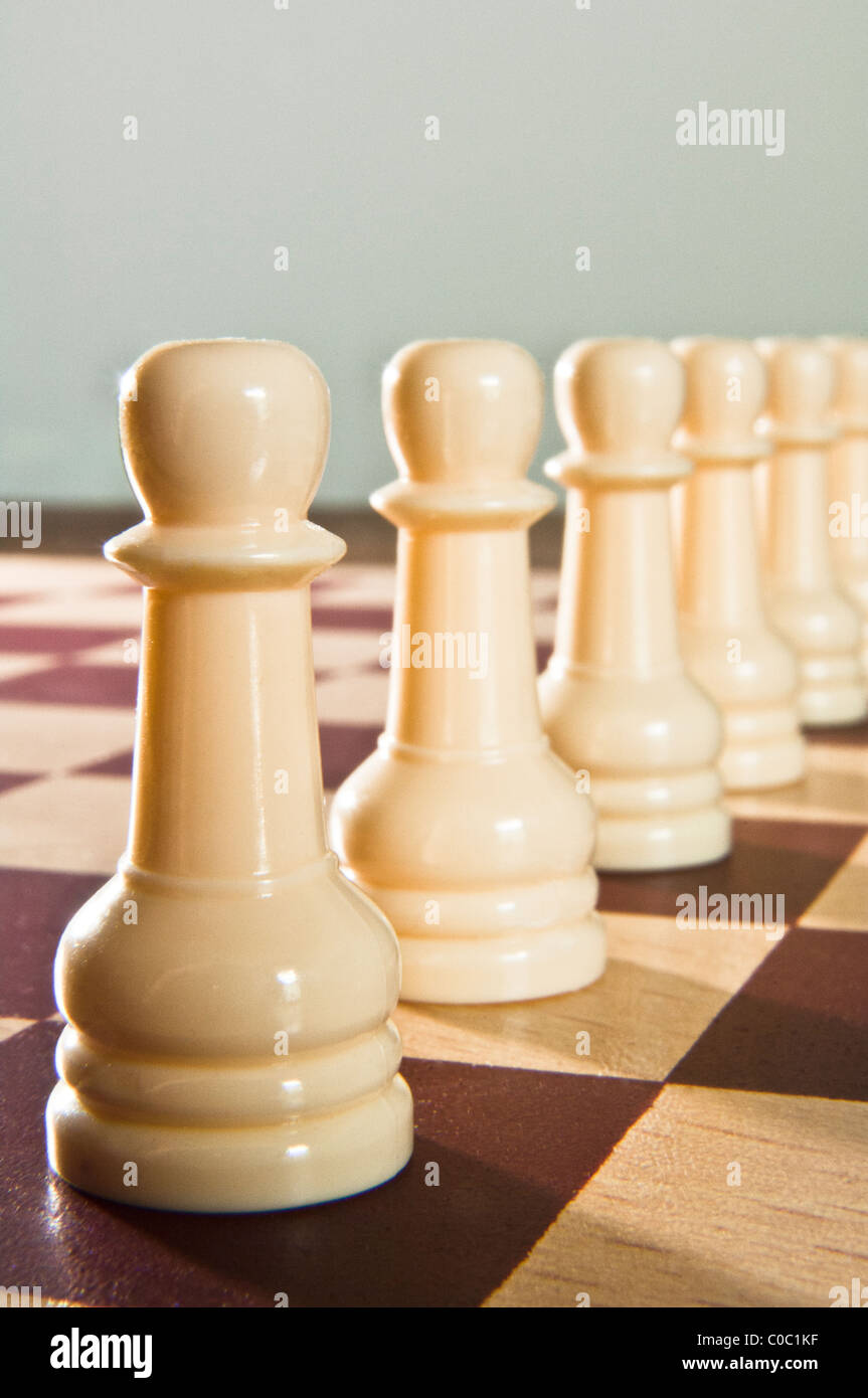 Rank of white chess pawns Stock Photo