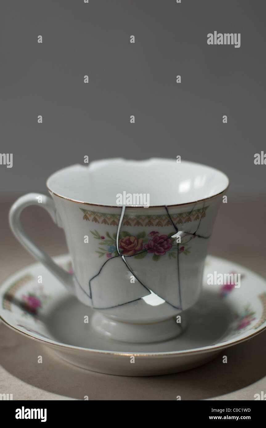 Clumsily repaired leaky teacup with cracks Stock Photo Alamy