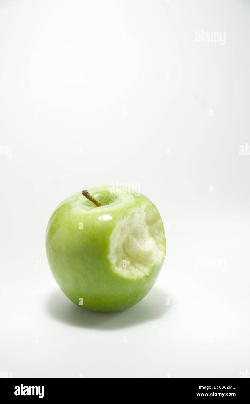 Green apple with a bite out Stock Photo