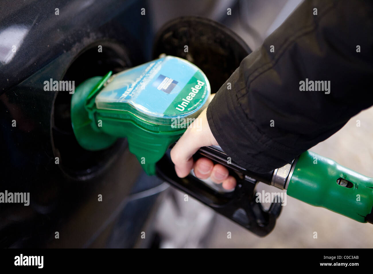a man putting petrol in car Stock Photo Alamy