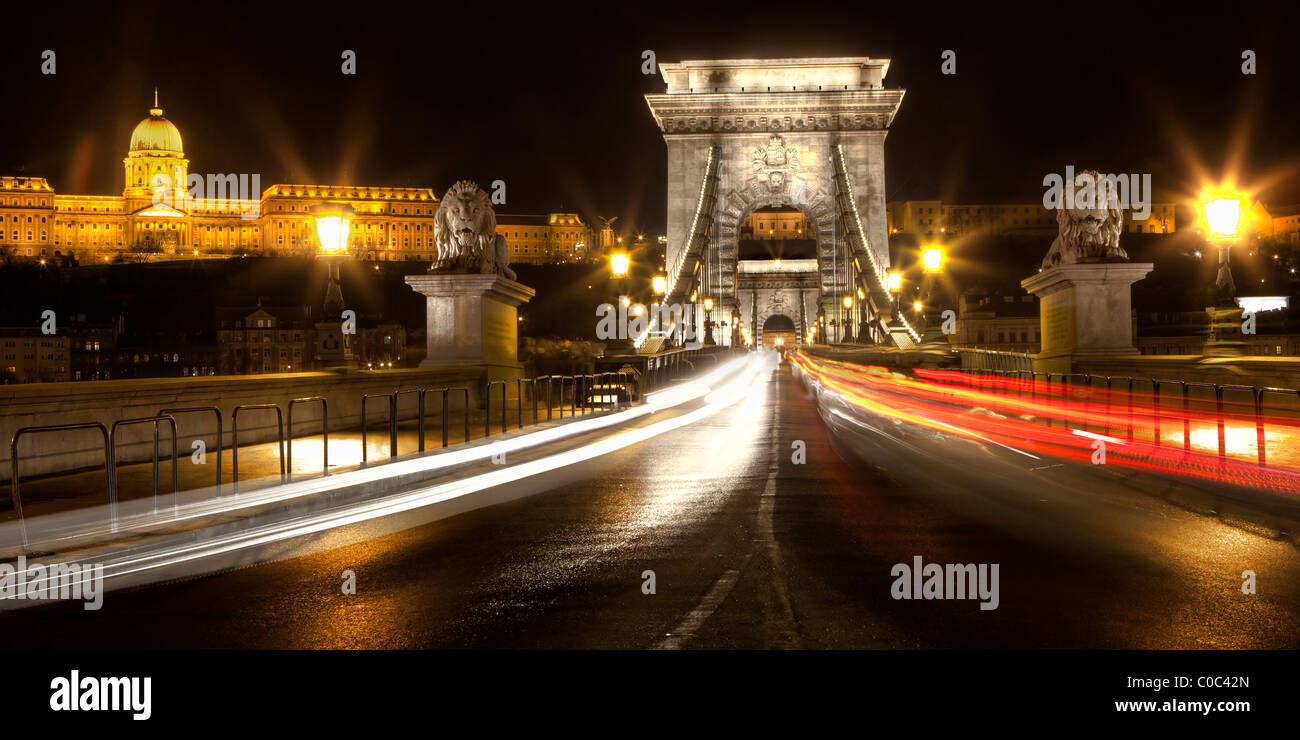 Chain Bridge at night in Budapest with The Royal Palace/Buda Castle in the background Stock Photo