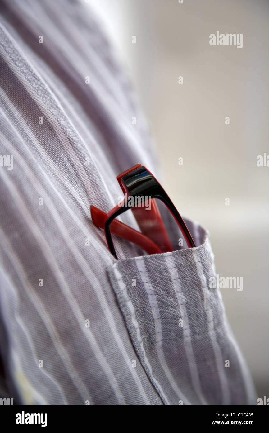 A pair of red spectacles in shirt pocket Stock Photo