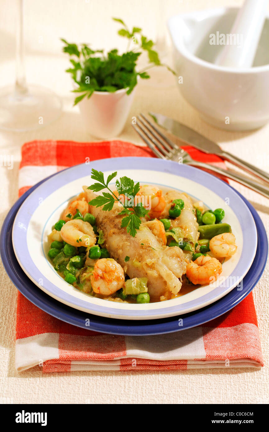 Monkfish tails with prawns and young garlics. Recipe available. Stock Photo