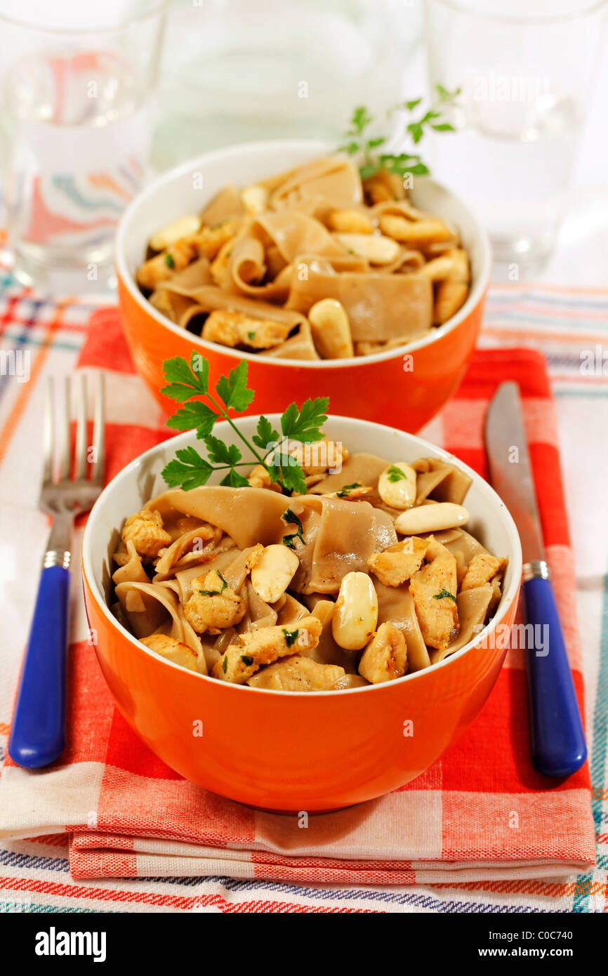 Mushrooms pasta with chicken and almonds. Recipe available. Stock Photo