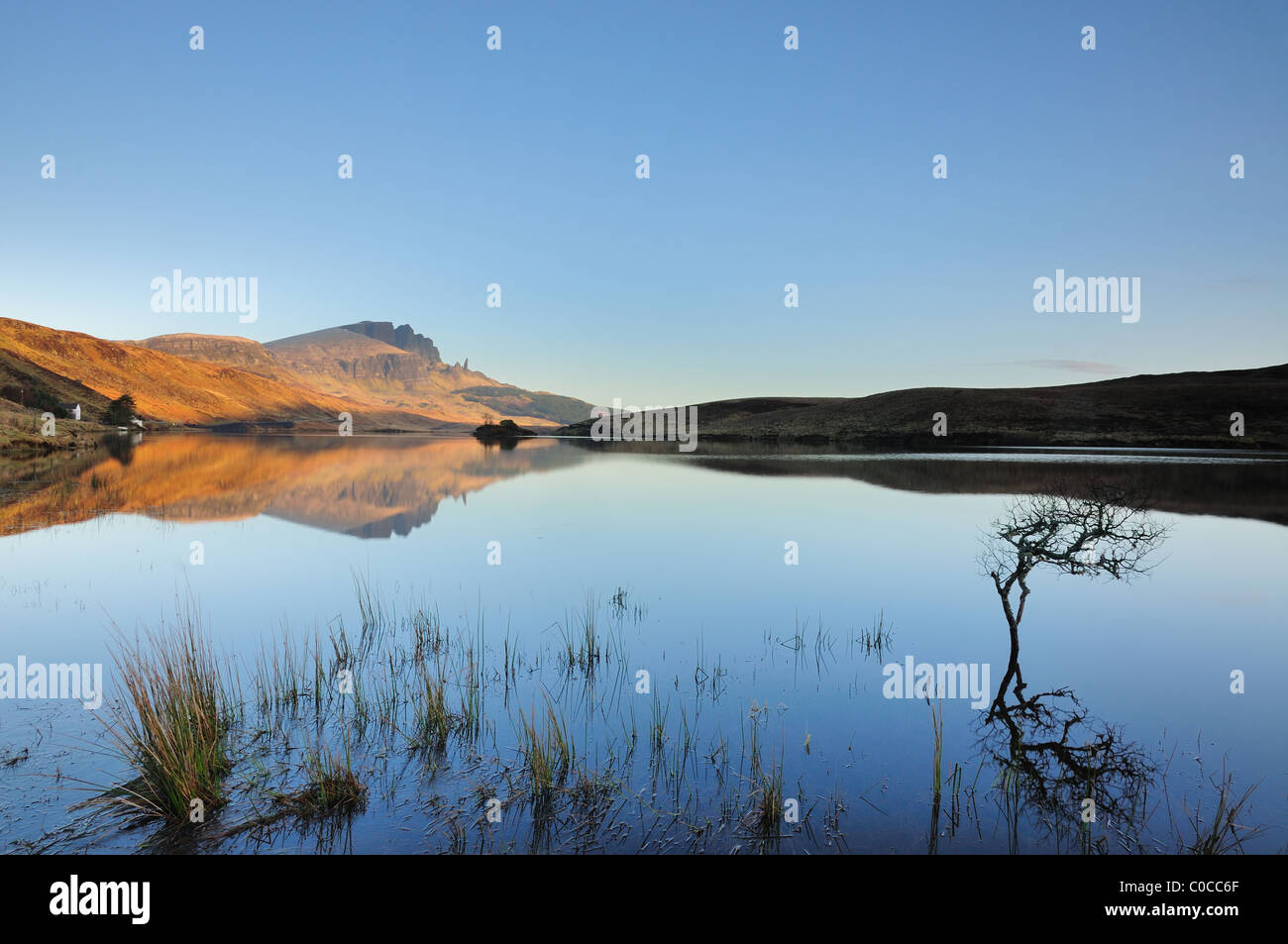 Storr and the Old Man of Storr reflected in Loch Leathan under clear blue skies on the Isle of Skye,Hebrides, Scottish Highlands Stock Photo