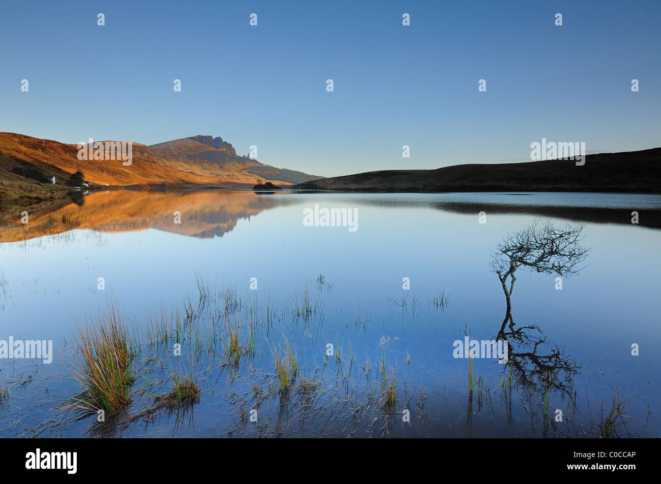 Storr and the Old Man of Storr reflected in Loch Leathan under clear blue skies on the Isle of Skye,Hebrides, Scottish Highlands Stock Photo