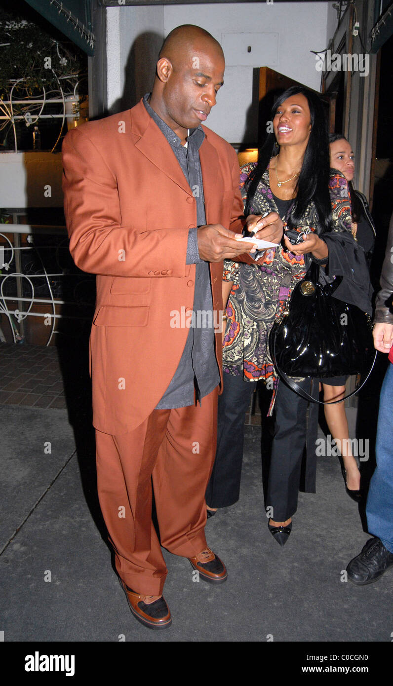 Former NFL player Deion Sanders leaving a restaurant after dining with