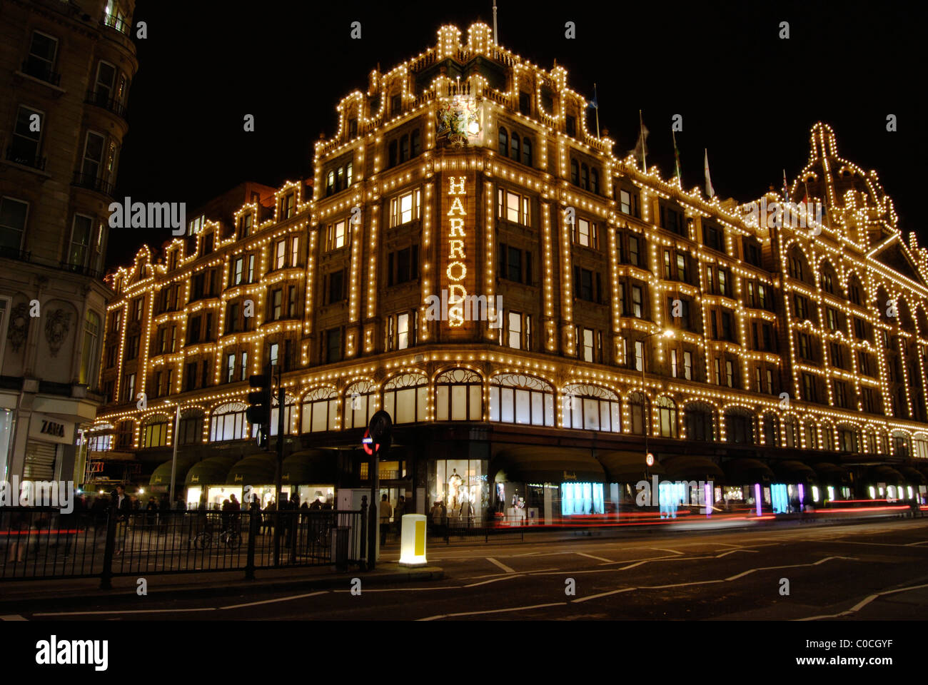 Harrods department store illuminated and the Brompton Road at night. London. England Stock Photo