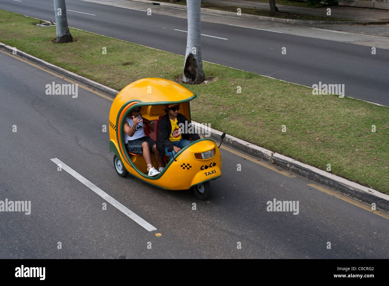 Coco Taxis Havana is the capital of Cuba 3 wheeled fiberglass yellow egg Stock Photo