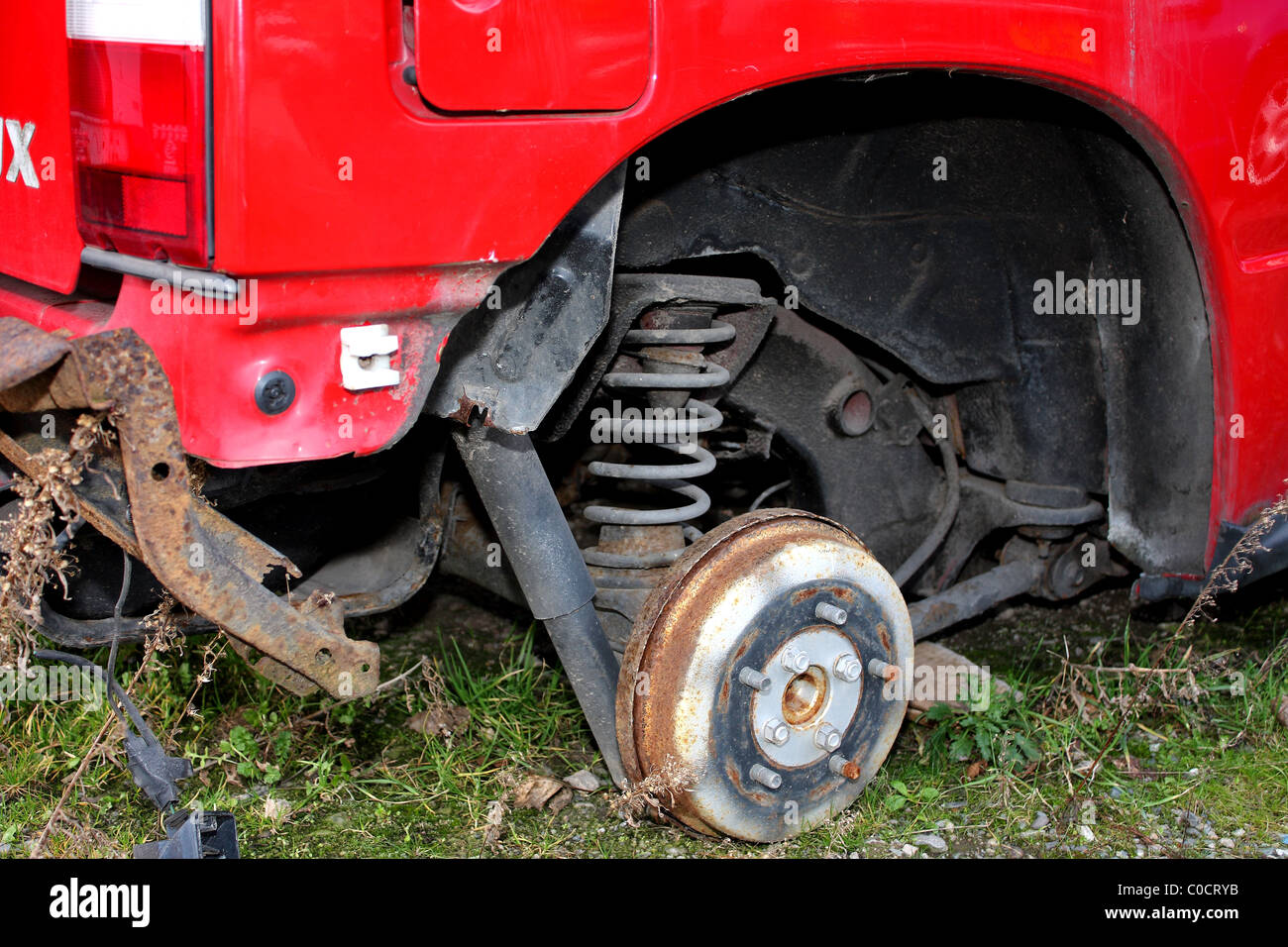 An old rusted wheel hub with the wheel and tyre missing and possibly stolen Stock Photo Alamy