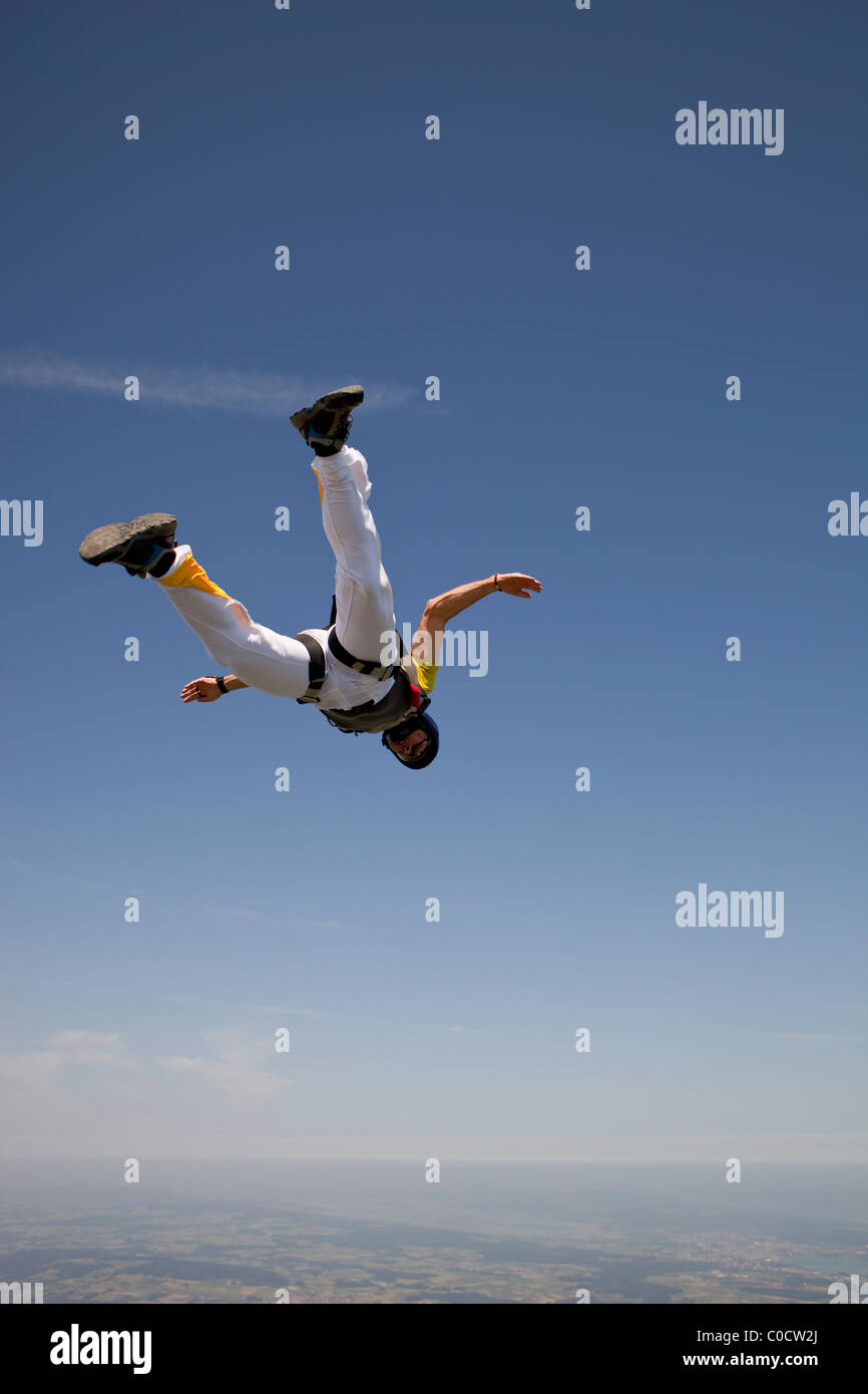 Man in tracking position is falling in freefall with over 130 MPH and having fun. Stock Photo
