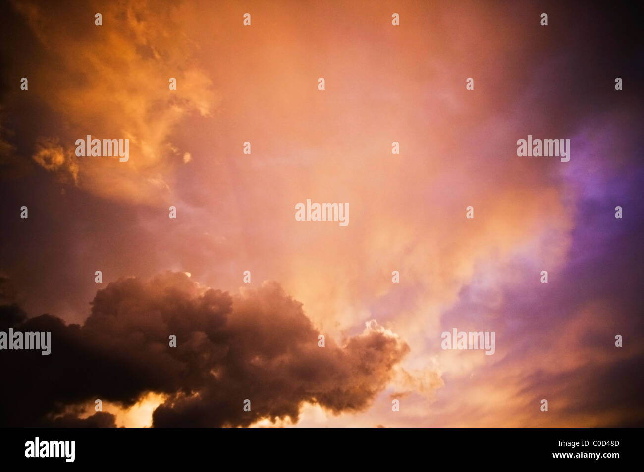 A dramatic orange and purple sky at sunrise or sunset. Stock Photo