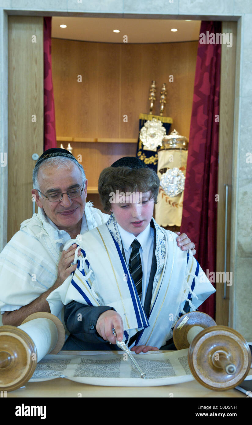 barmitzvah boy learning his Torah portion with Rabbi Stock Photo