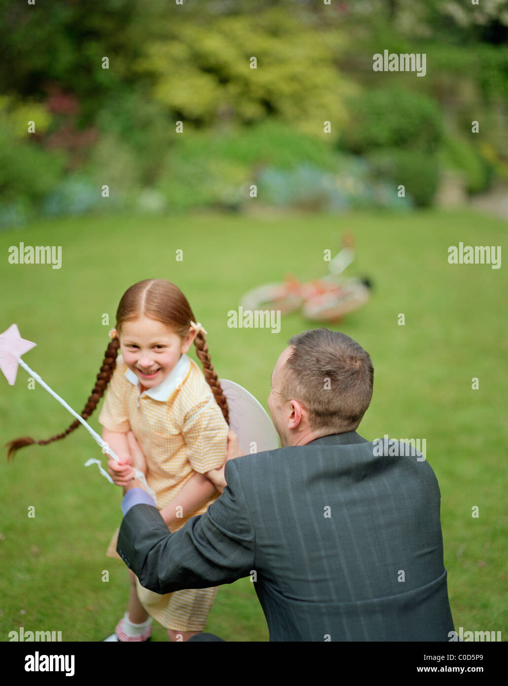 Father and daughter playing with fairy wand Stock Photo